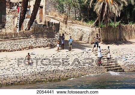 Boys By The Shore Of The Nile River Between Aswan And Edfu, Aswan, Egypt View Large Photo Image Stock Image - Boys By The Shore Of The Nile River Between Aswan And Edfu, Aswan, Egypt. Fotosearch