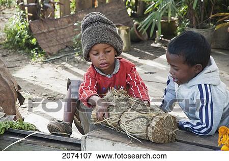 Stock Photo - Boys I9N The Flower Market By Lake Anosy In Antananarivo, Madagascar. Fotosearch