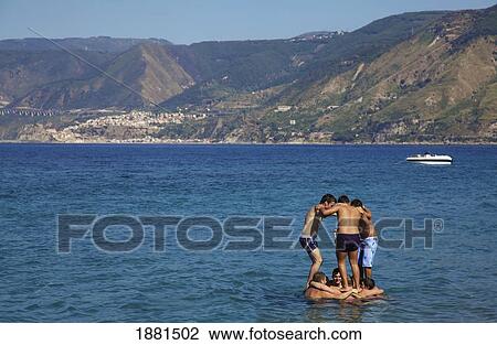 Boys Playing In The Water; Messina, Sicily, Italy View Large Photo Image Stock Image - Boys Playing In The Water; Messina, Sicily, Italy. Fotosearch