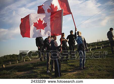 Boys wave Canadian flags during Canada Day celebrations; Saskatoon, Saskatchewan, Canada View Large Photo Image Stock Photo - Boys wave Canadian flags during Canada Day celebrations; Saskatoon, Saskatchewan, Canada. Fotosearch
