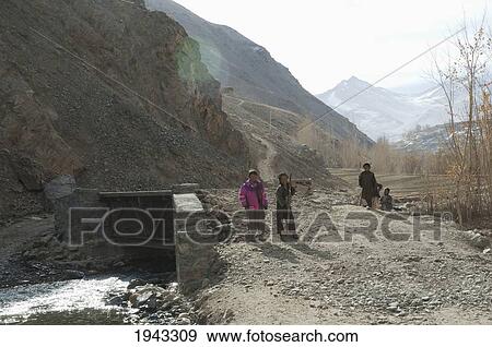 Stock Photo - Boys Working On A Culvert Over A Stream In Aab-E-Noraq, Bamian Province, Afghanistan. Fotosearch