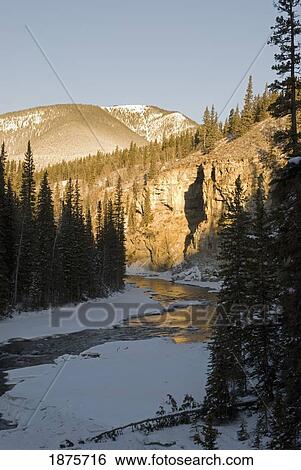 Stock Photograph - Bragg Creek, Alberta, Canada; A Winter Sunrise On The Elbow River. Fotosearch