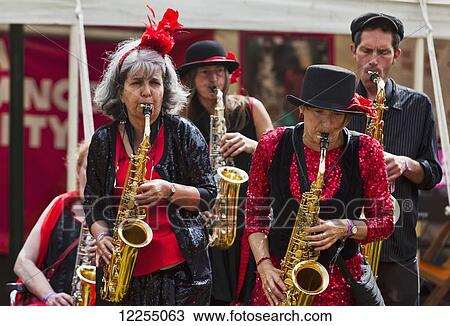 Stock Image - Brass band busking at music festival; Dorset, England. Fotosearch