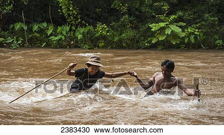 Stock Image - Brave river crossing; Sen Monorom, Mondulkiri, Cambodia. Fotosearch