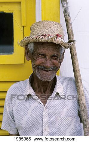 Brazil, Buzios, Portrait Of Local Man Standing Next To Yellow Door With Walking Stick. View Large Photo Image Stock Photography - Brazil, Buzios, Portrait Of Local Man Standing Next To Yellow Door With Walking Stick.. Fotosearch