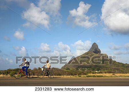Brazil, Pernambuco, Cyclists and Morro do Pico in background; Fernando de Noronha View Large Photo Image Stock Image - Brazil, Pernambuco, Cyclists and Morro do Pico in background; Fernando de Noronha. Fotosearch