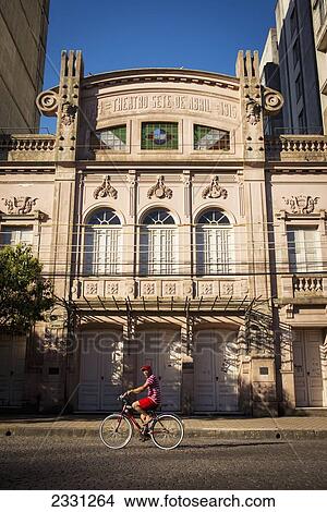 Brazil, Rio Grande do Sul, Teenager on bike in front of Theatro Sete de Abril in residential district; Pelotas View Large Photo Image Picture - Brazil, Rio Grande do Sul, Teenager on bike in front of Theatro Sete de Abril in residential district; Pelotas. Fotosearch