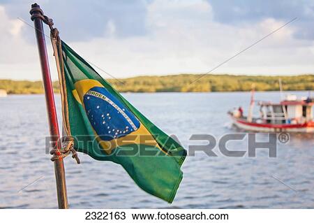 Brazilian flag with boat in water in background; Puerto Seguro, Brazil View Large Photo Image Stock Image - Brazilian flag with boat in water in background; Puerto Seguro, Brazil. Fotosearch