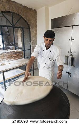 Stock Image - Bread Making At The Bakery At Haret Jdoudna, Madaba, Jordan, Middle East. Fotosearch