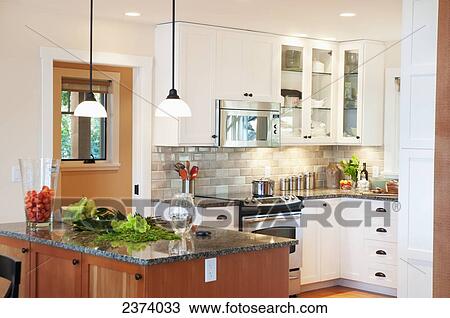 Stock Image - Breakfast Bar In Modern Kitchen; Mayne Island, British Columbia, Canada. Fotosearch