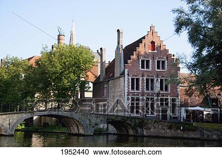 Stock Image - Bridge over a canal, Bruges (Brugge), West Flanders, Belgium. Fotosearch