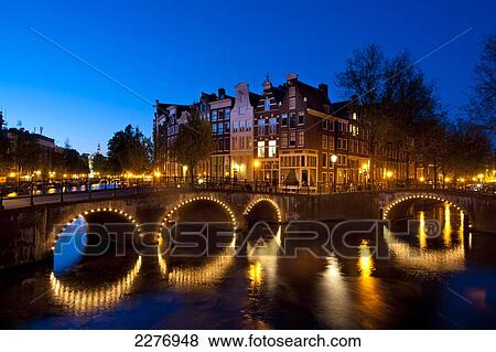 Bridges over canals at dusk; Amsterdam, Holland View Large Photo Image Stock Photo - Bridges over canals at dusk; Amsterdam, Holland. Fotosearch