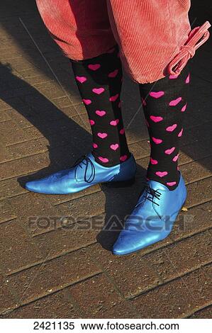 Stock Photography - Bright blue pointed toed shoes, heart socks and short pants, Portobello Road Market; London, England. Fotosearch