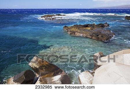 Stock Photography - Bright clear water and rock formations at Kaumalapau Harbour; Lanai, Hawaii, United States of America. Fotosearch