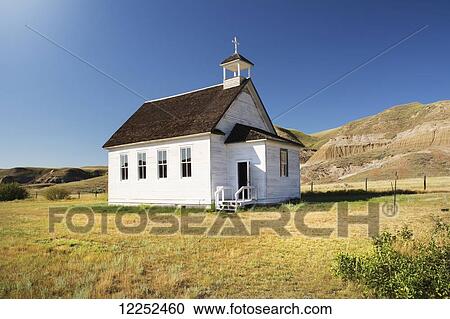 Stock Image - Bright white little church in the badlands; Dorothy, Alberta, Canada. Fotosearch