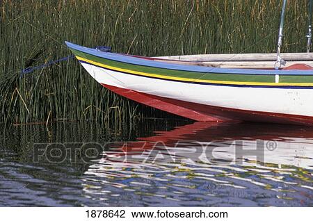 Stock Image - Brightly Painted Boat Among Reeds In Lake Titicaca. Fotosearch