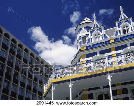 Stock Photography - Brightly Painted Colonial Building And Modren Office Building, Long Street, Cape Town, South Africa.. Fotosearch