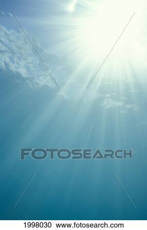 Stock Image - Brilliant Sunburst Through Water Surface With Sunrays, View From Underwater. Fotosearch