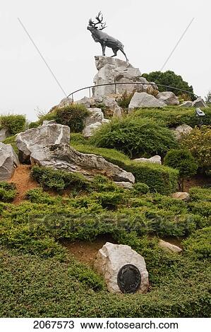 Stock Image - Bronze Caribou Stag, The Emblem Of The Newfoundland Regiment, On A Mound At The Beumont-Hamel Newfoundland Memorial, Somme, France. Fotosearch