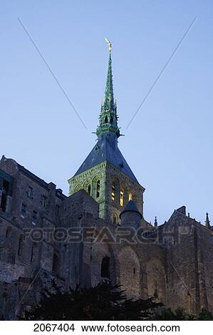 Bronze Neo-Gothic Spire Designed By The Architect Petit Grand In 1897, On The Abbey Of Mont Saint-Michel In The Evening, France View Large Photo Image Picture - Bronze Neo-Gothic Spire Designed By The Architect Petit Grand In 1897, On The Abbey Of Mont Saint-Michel In The Evening, France. Fotosearch