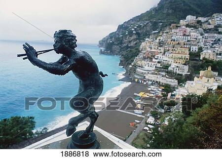 Stock Photo - Bronze Of Pan Above Town With Ocean. Fotosearch