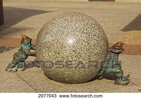 Bronze Sculptures Of Two Gnomes Pushing A Boulder; Wroclaw Poland View Large Photo Image Stock Image - Bronze Sculptures Of Two Gnomes Pushing A Boulder; Wroclaw Poland. Fotosearch