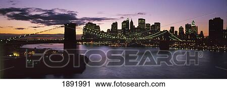 Stock Image - Brooklyn Bridge And Lower Manhattan At Dusk From Manhattan Bridge. Fotosearch