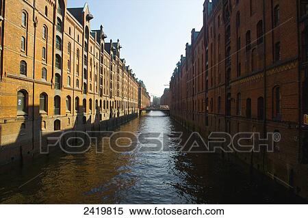 Brown brick buildings along a canal under a blue sky; Hamburg, Germany View Large Photo Image Stock Photography - Brown brick buildings along a canal under a blue sky; Hamburg, Germany. Fotosearch