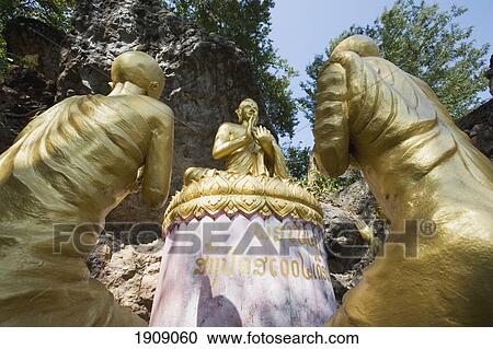 Stock Image - Buddha Statues On Phu Si Hill, Low Angle View, Luang Prabang, Laos. Fotosearch