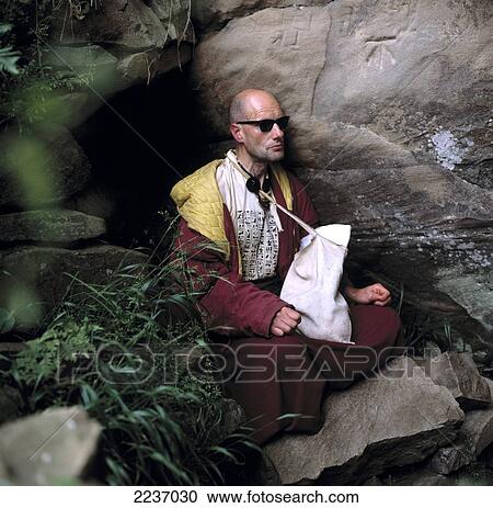 Stock Image - Buddhism (Man Meditating) Holy Island, The Hebrides - Scotland. Fotosearch