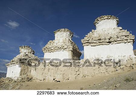 Stock Image - Buddhist chortens on a hill overlooking the Indus Valley and Leh. Leh was the capital of the Himalayan kingdom of Ladakh, now the Leh District in the state of Jammu and Kashmir, India. Leh is at an altitude of 3, 500 meters (11, 483 ft).. Fotosearch