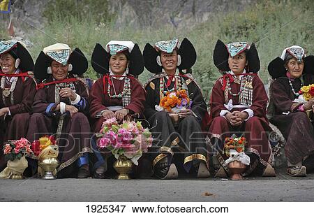 Buddhist Ladakhi Women Wearing Traditional Dress And Hats With Long Plaited Hair And Headdress With Turquoise Stones And Flowers, Diskyid (Disket / Diskit), Nubra Valley, Leh, Ladakh, Indian Himalayas, India View Large Photo Image Stock Photo - Buddhist Ladakhi Women Wearing Traditional Dress And Hats With Long Plaited Hair And Headdress With Turquoise Stones And Flowers, Diskyid (Disket / Diskit), Nubra Valley, Leh, Ladakh, Indian Himalayas, India. Fotosearch