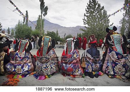 Stock Photograph - Buddhist Ladakhi Women Wearing Traditional Dress And Hats With Long Platted Hair And Head Dress With Turquoise Stones. Fotosearch