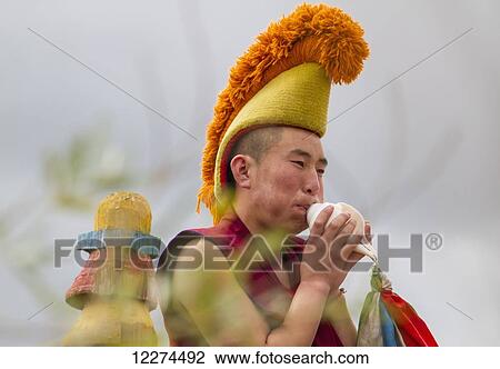Stock Image - Buddhist monk blowing a conch shell by the Larviran Temple at the Erdene Zuu Monastery, Karakorum (Kharkhorin),? vÃƒÆ’Ã‚Â·rkhangai Province, Mongolia. Fotosearch