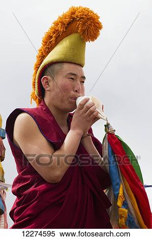 Buddhist monk blowing a conch shell by the Larviran Temple at the Erdene Zuu Monastery, Karakorum (Kharkhorin),? v÷rkhangai Province, Mongolia View Large Photo Image Stock Photography - Buddhist monk blowing a conch shell by the Larviran Temple at the Erdene Zuu Monastery, Karakorum (Kharkhorin),? v÷rkhangai Province, Mongolia. Fotosearch