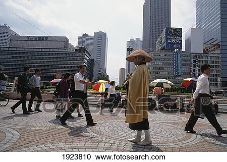 Stock Image - Buddhist Monk Contrasts. Fotosearch