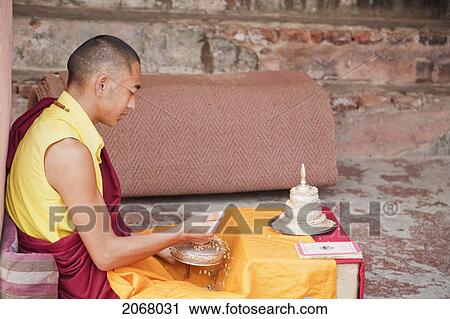 Stock Image - Buddhist Monk In Meditation Exercises, Mahabodi Temple, Bodhgaya, Bihar, India. Fotosearch