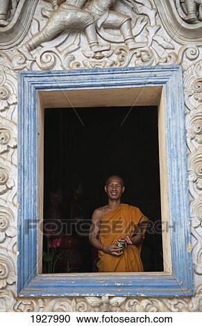 Stock Image - Buddhist Monk In Window. Fotosearch