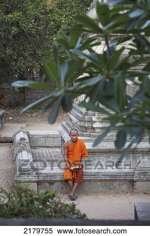 Buddhist Monk reading at Wat Bo Temple Cambodia View Large Photo Image Stock Photography - Buddhist Monk reading at Wat Bo Temple Cambodia. Fotosearch