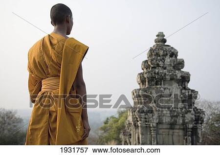 Buddhist Monk Standing Next To Temple On Hill Top, Angkor Wat View Large Photo Image Stock Photo - Buddhist Monk Standing Next To Temple On Hill Top, Angkor Wat. Fotosearch
