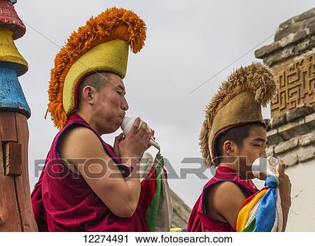 Stock Image - Buddhist monks blowing conch shells by the Larviran Temple at the Erdene Zuu Monastery, Karakorum (Kharkhorin),? vÃƒÆ’Ã‚Â·rkhangai Province, Mongolia. Fotosearch