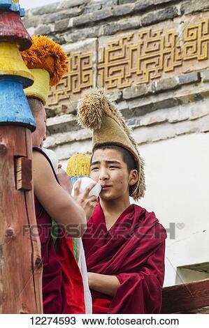 Stock Image - Buddhist monks blowing conch shells by the Larviran Temple at the Erdene Zuu Monastery, Karakorum (Kharkhorin),? vÃƒÆ’Ã‚Â·rkhangai Province, Mongolia. Fotosearch