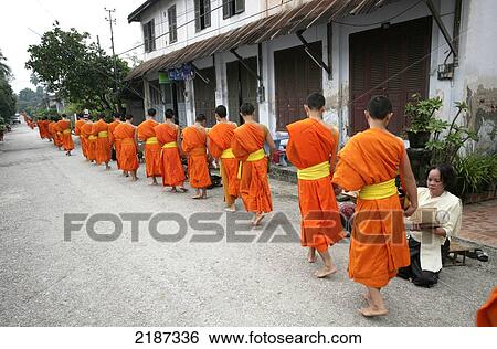 Buddhist monks collecting alms; Luang Prabang, Laos View Large Photo Image Stock Photograph - Buddhist monks collecting alms; Luang Prabang, Laos. Fotosearch