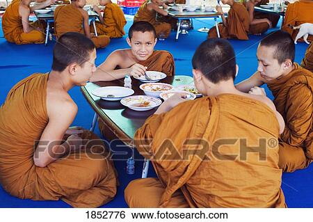 Stock Photograph - Buddhist Monks Eating In Thailand. Fotosearch