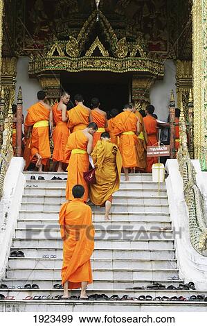 Stock Photo - Buddhist Monks Walking Up The Stair To Temple, Luang Prabang, Laos. Fotosearch