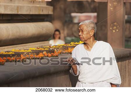 Stock Image - Buddhist Nun By The Ratnachankramas, Mahabodi Temple, Bodhgaya, Bihar, India. Fotosearch