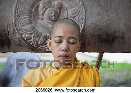 Stock Photograph - Buddhist Nun Meditating, Mahabodi Temple, Bodhgaya, Bihar, India. Fotosearch