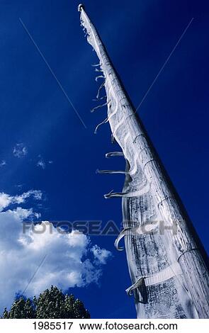 Stock Photo - Buddhist prayer flag extending towards deep blue sky; Bhutan. Fotosearch