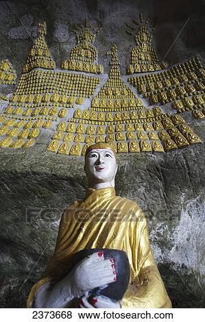 Stock Photo - Buddhist statue in Saddar cave close to Hpa-An; Kayin State, Burma. Fotosearch