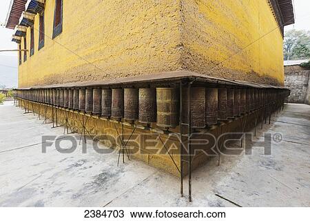 Buddhist temple wall with prayer wheels at Longwu Tibetan monastery; Tibet, China View Large Photo Image Stock Image - Buddhist temple wall with prayer wheels at Longwu Tibetan monastery; Tibet, China. Fotosearch